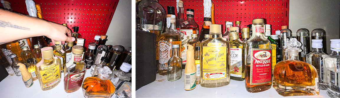 Many bottles stacked on a tabletop.